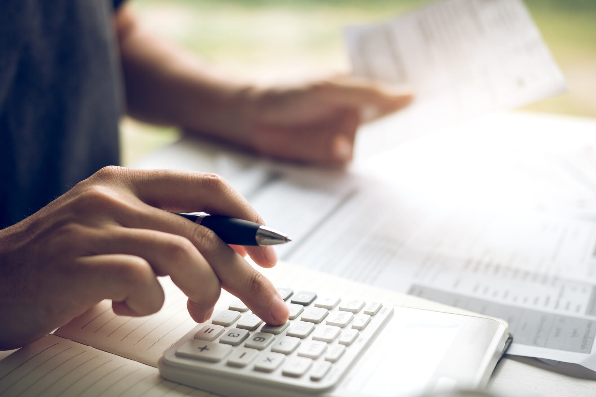 Man use calculators and documents that calculate expenses in the